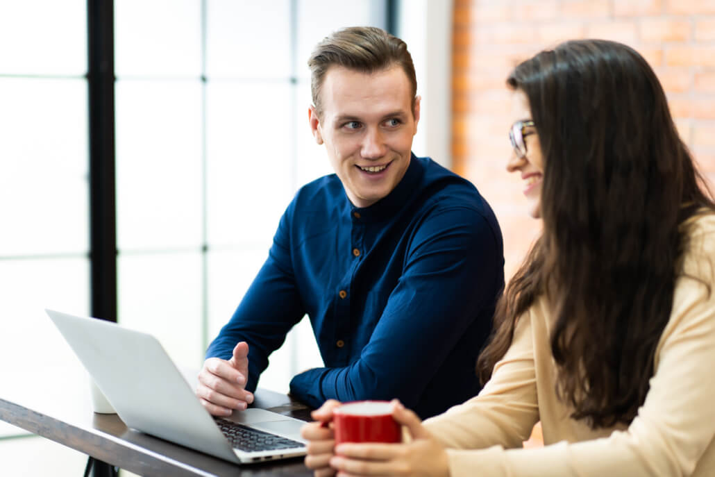 Young caucasian couple using laptop