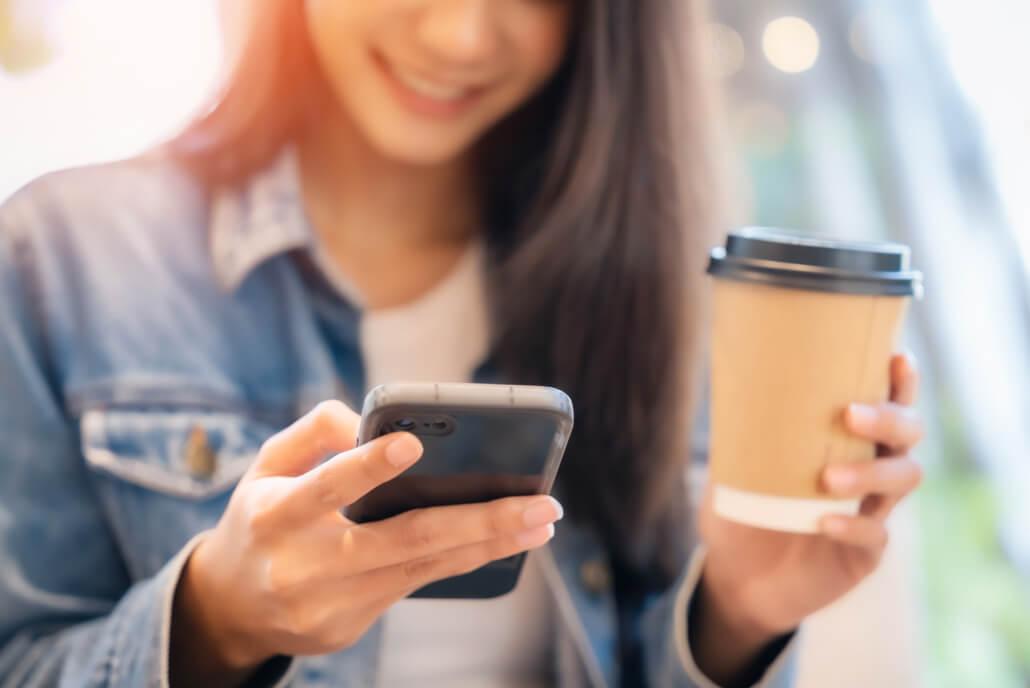 woman using smart phone in coffee shop cafe