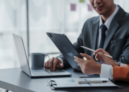 Staff using two laptops