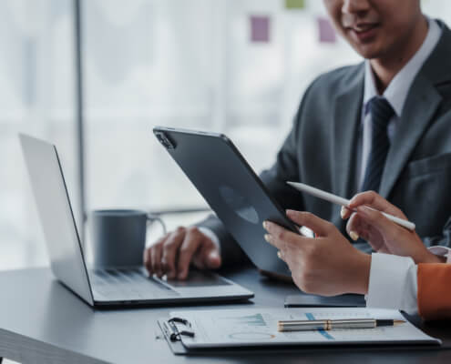 Staff using two laptops