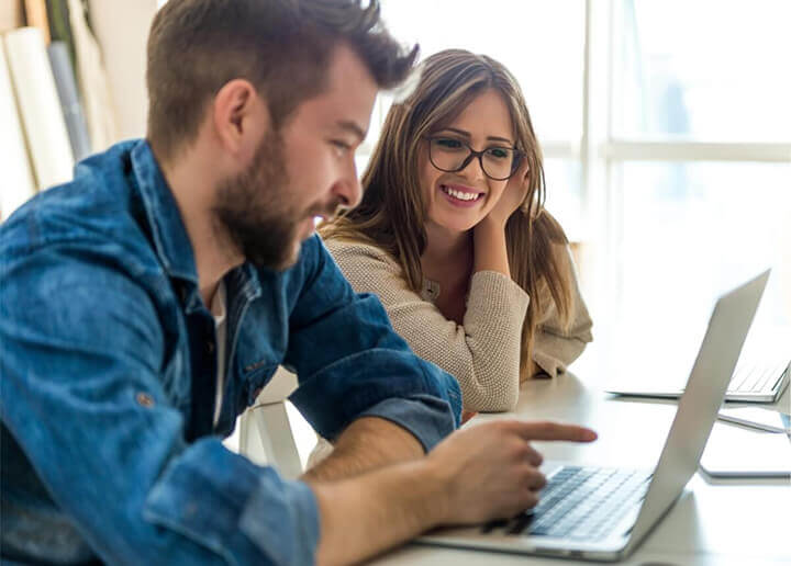 couple checking the laptop screen